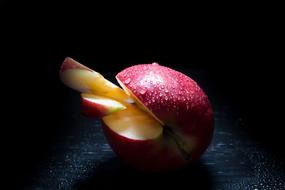 wet apple in a cut in the dark