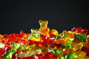 photo of multi-colored chewing bears on a black background