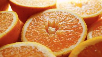 Beautiful cut in half oranges in light