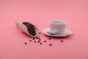 Coffee Beans and hot drink on pink