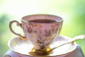 cup of tea with a gold pattern