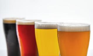 four glasses with beer in row