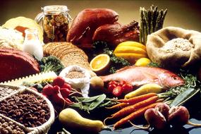 Colorful fresh vegetables, bread, fish and beans on the table