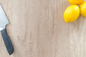 Knife and limon on wooden table