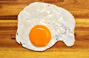 Fried Egg on wooden surface