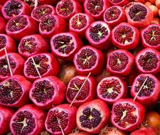 peeled ripe pomegranates on market stall