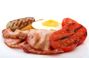 fried bacon, fried egg, grilled sausage and grilled tomatoes for breakfast