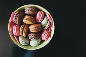 colorful macaroons in Bowl at black background