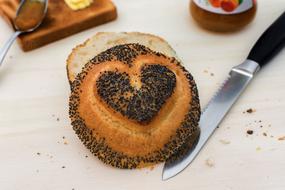 cut bun with poppy seeds on the table