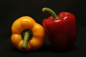 yellow and red peppers on a black background