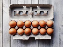 brown eggs in a cardboard box on the table