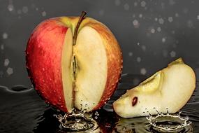 Colorful sliced apple in a puddle in the rain