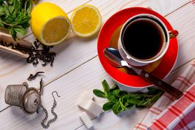 cup of tea, lime, mint and sugar on the table
