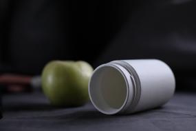 Apple and white bottle
