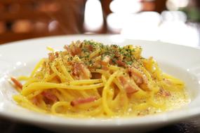 carbonara pasta on a plate in a restaurant