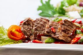 meat with chili peppers in a restaurant