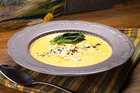 cheese soup in a silver plate