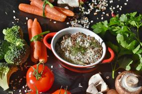 risotto with brown mushrooms and fresh vegetables on the table