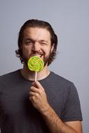 adult man eating Lollipop, Portrait