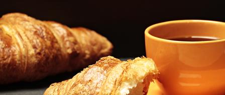 fresh tasty croissants and a cup of tea