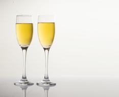 photo of two glasses of champagne on a glass table