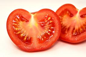 Red sliced tomato at white background