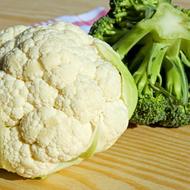 Cauliflower and Broccoli, raw cabbage on the wooden board