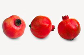 three red pomegranates on white