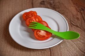 sliced tomato on the white plate