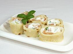 salmon rolls with cream on a plate