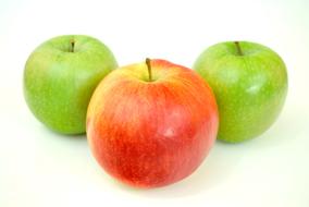 Closeup picture of two green and one red apples