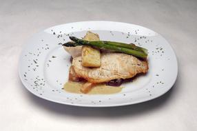 fish stew with asparagus in a restaurant