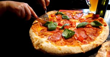 pizza with sausage and basil