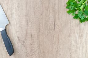 Knife and herb on wooden board