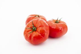 photo of three ripe tomatoes on a white background