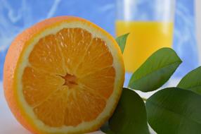 Orange Juice Vitamins and green leaves