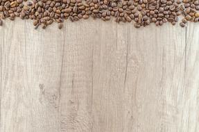 coffee beans on a light wooden table