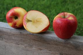 seasonal red apples on a wooden bench