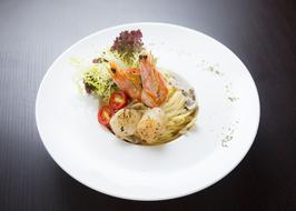 Colorful seafood pasta with vegetables in a restaurant