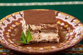 tiramisu with mint leaves on a plate