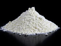 pile of Flour on black glossy background
