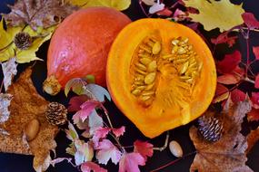 orange Hokkaido Pumpkin on colorful autumn leaves