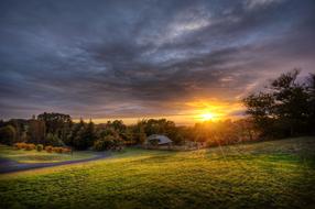 sunset in the cloudy sky over the countryside