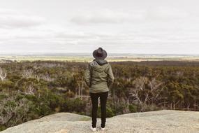 photo of a girl in a hat on a high hill