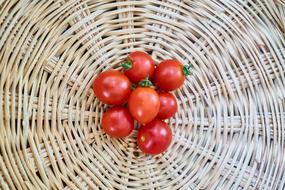 small red tomatoes in a wicker basket