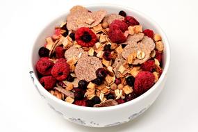 muesli with berries in a white bowl