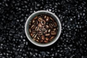 Cup with roasted Coffee Beans, top view