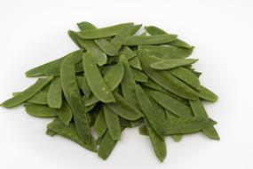 photo of pea pods on a white background