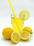 lemonade in a glass and ripe lemons