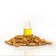 almond oil in a transparent bottle and almonds